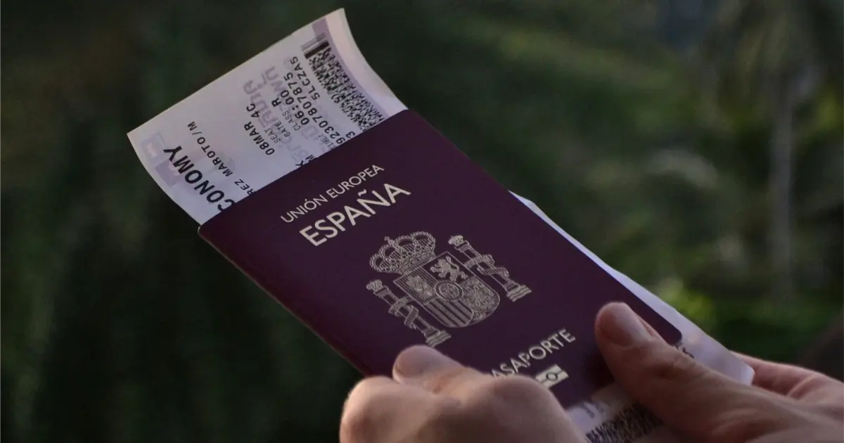 Close-up of a Spanish passport with boarding pass, symbolizing visas, residency, and travel to Spain