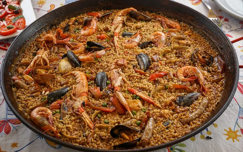 seafood-paella-traditional-spanish-dish Seafood paella with prawns, mussels and saffron rice, iconic traditional dish of Spain