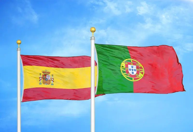 spain-portugal-flags-cost-of-living-comparison Flags of Spain and Portugal side by side, illustrating cost of living comparison between both countries