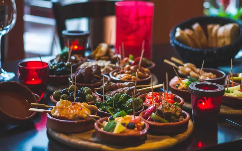 spanish-tapas-traditional-cuisine Assortment of traditional Spanish tapas with olives, vegetables and meats served in small portions